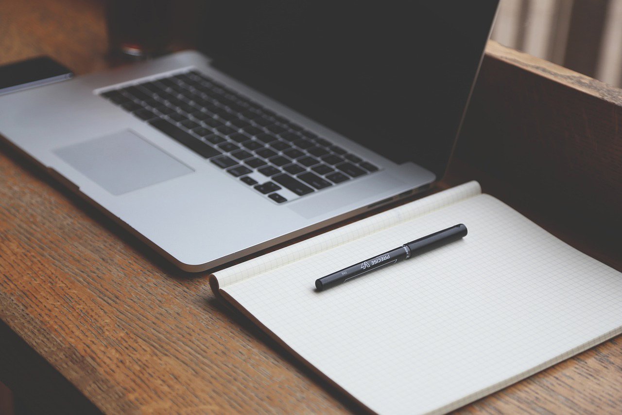 laptop with notepad for making appointments